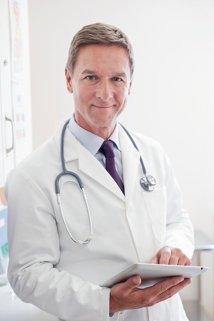 Male doctor using tablet