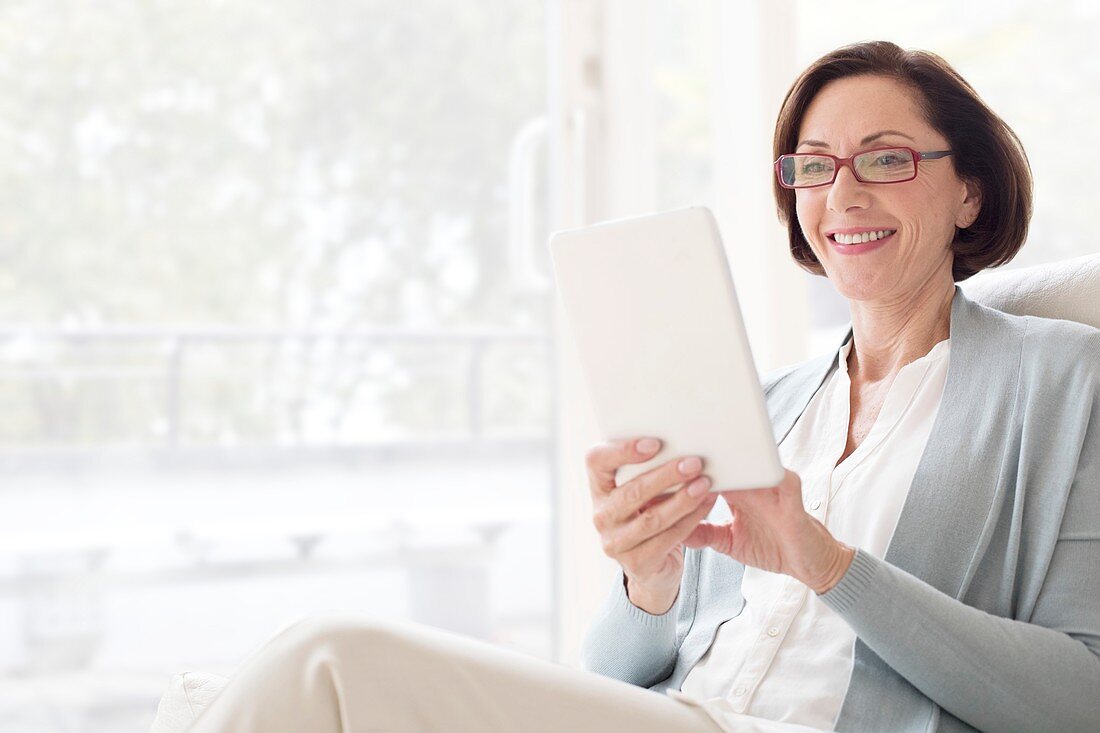 Mature woman using digital tablet