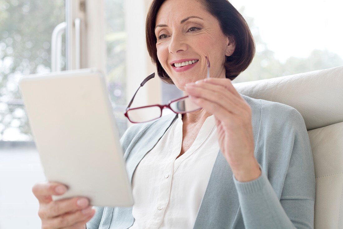 Mature woman using digital tablet