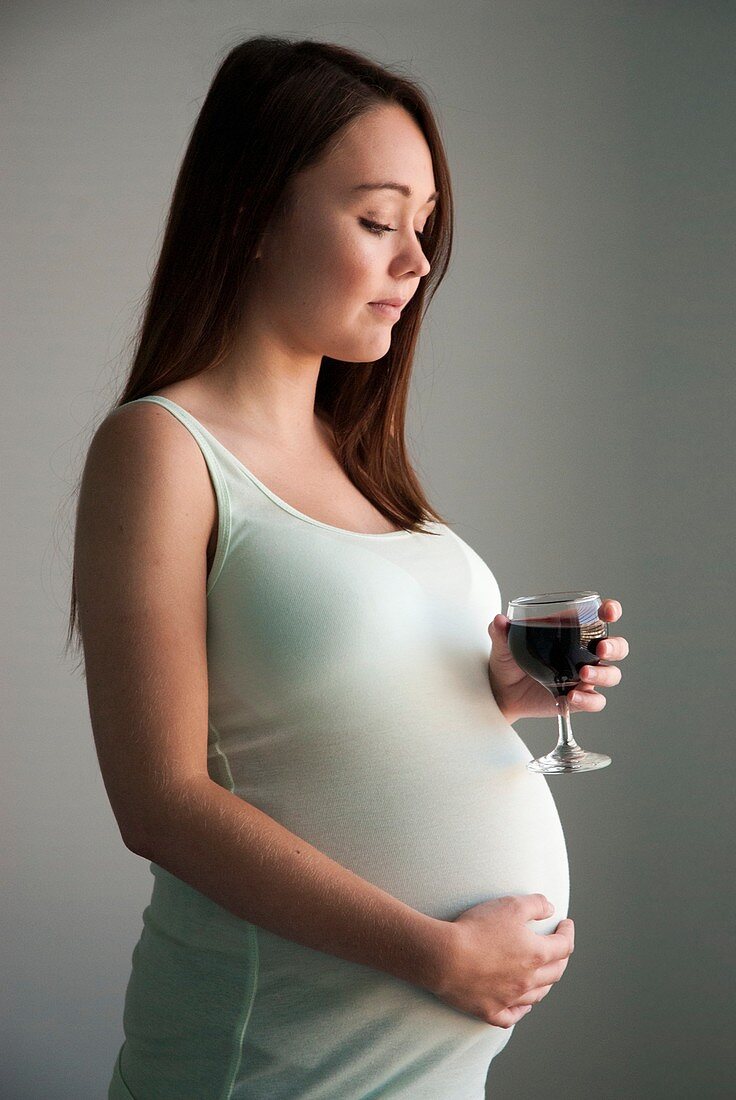 Pregnant teenager drinking wine