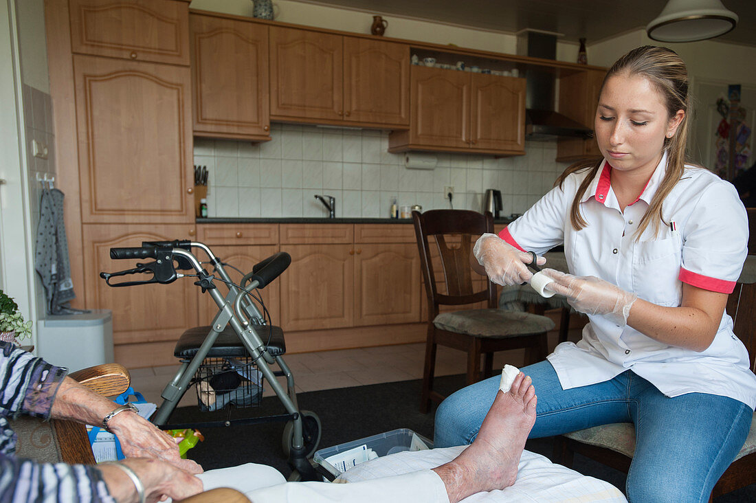 Nurse dressing a foot wound