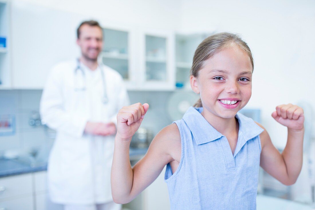 Portrait of girl cheering in doctor's surgery