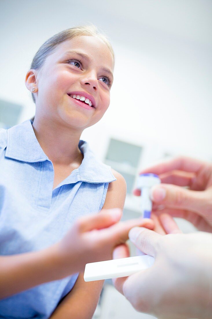 Doctor giving girl a finger prick test