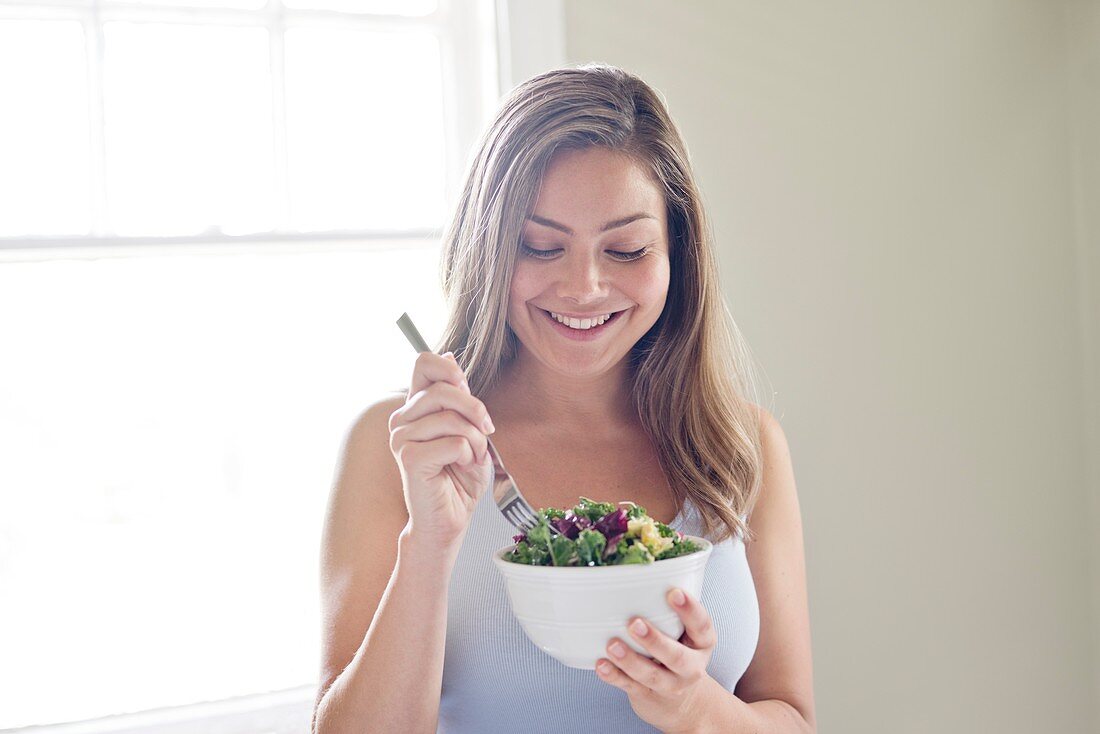 Woman eating salad