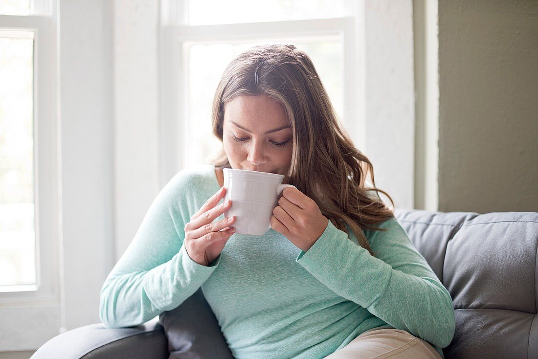 Woman drinking hot drink from a mug