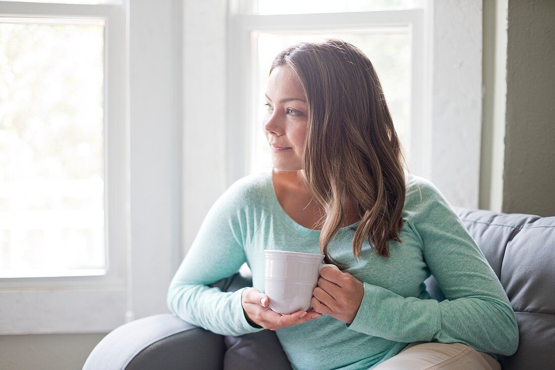 Woman holding a mug and looking away