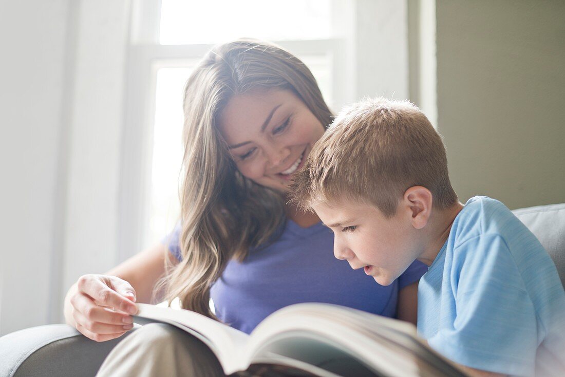 Mother and son reading a book together