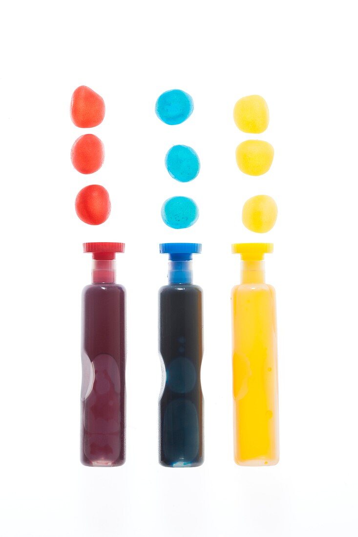 Three containers with coloured liquid spots