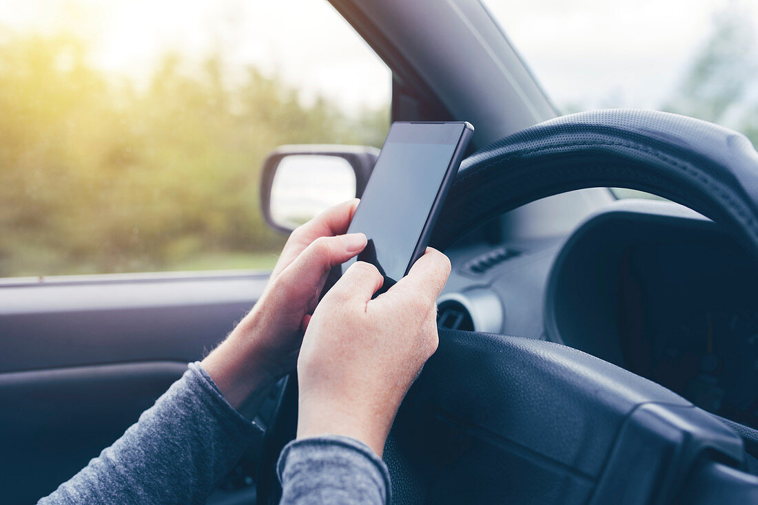 Woman driving and texting