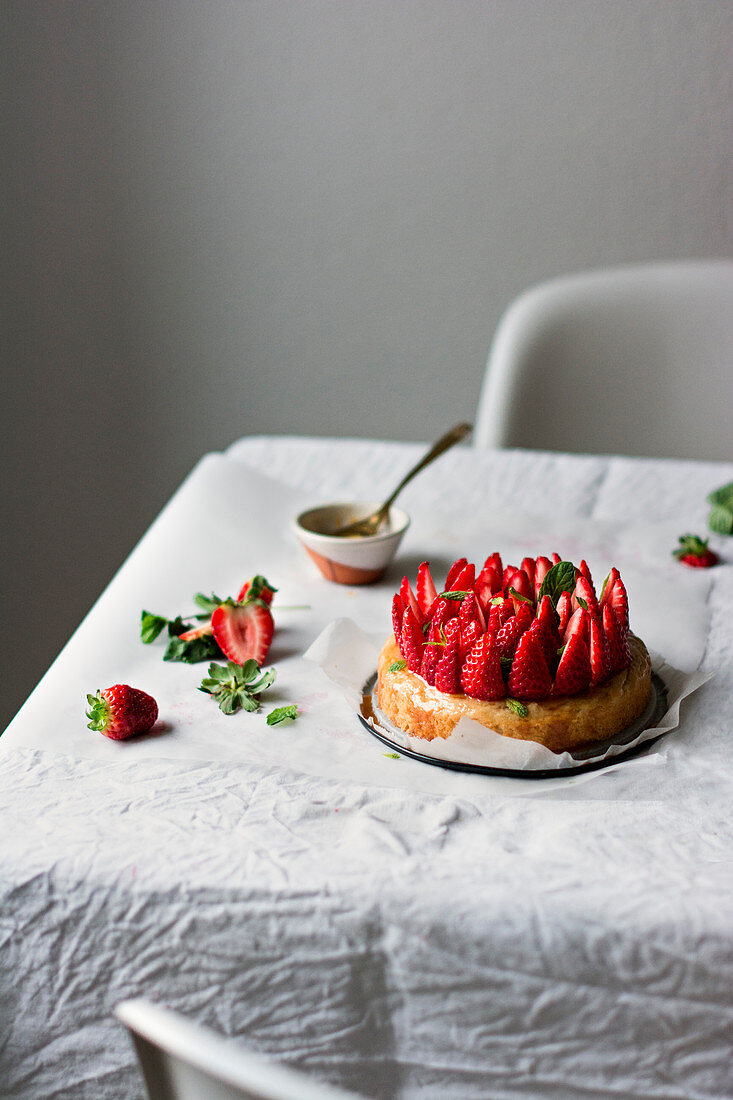 A basil cake with fresh strawberries and mint syrup