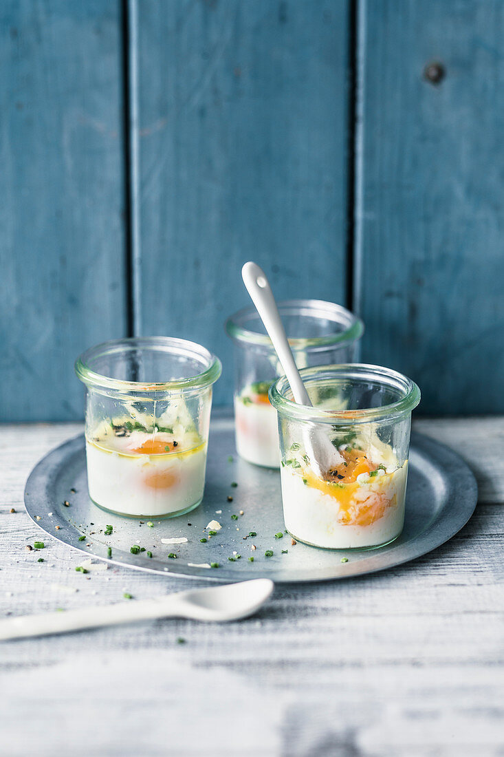 Eggs in jars with chives and Parmesan