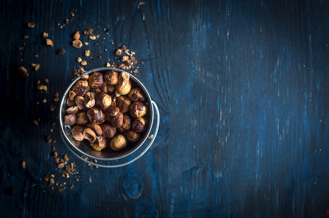 Sliced and fried hazelnuts on the wooden background