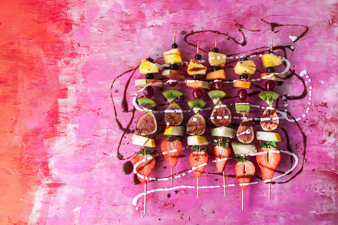 Fruit kebabs with chocolate sauce and coconut cream