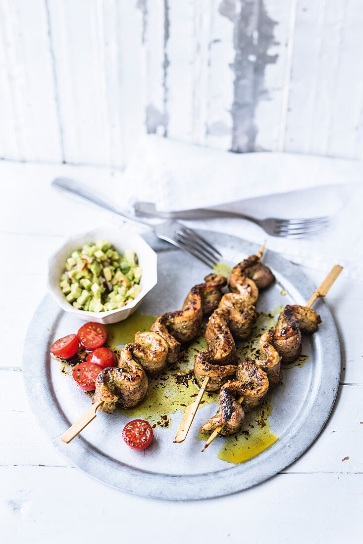 Marinated duck skewers with avocado tartare