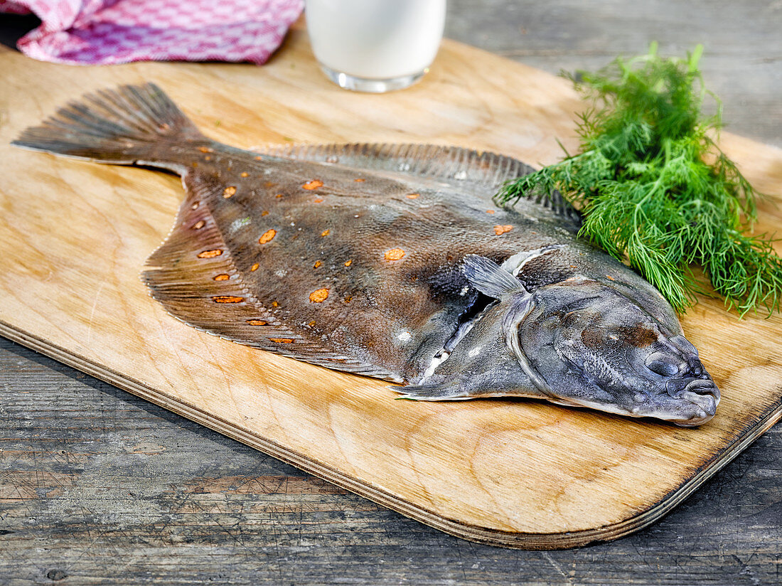 A flounder on a wooden board