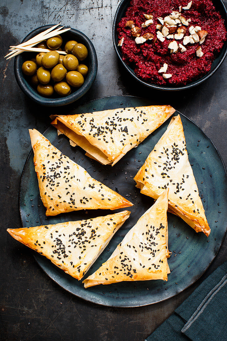 Filo pastry triangles with beetroot cream and olives