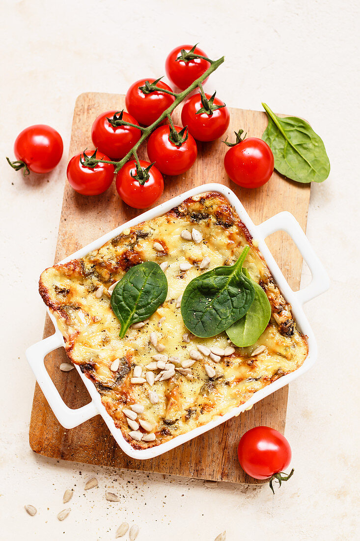 Spinach and tomato bake with cheese and sunflower seeds