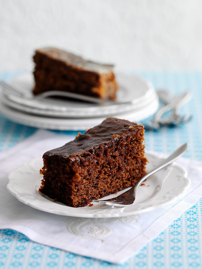 Two slices of ginger cake with a chocolate glaze