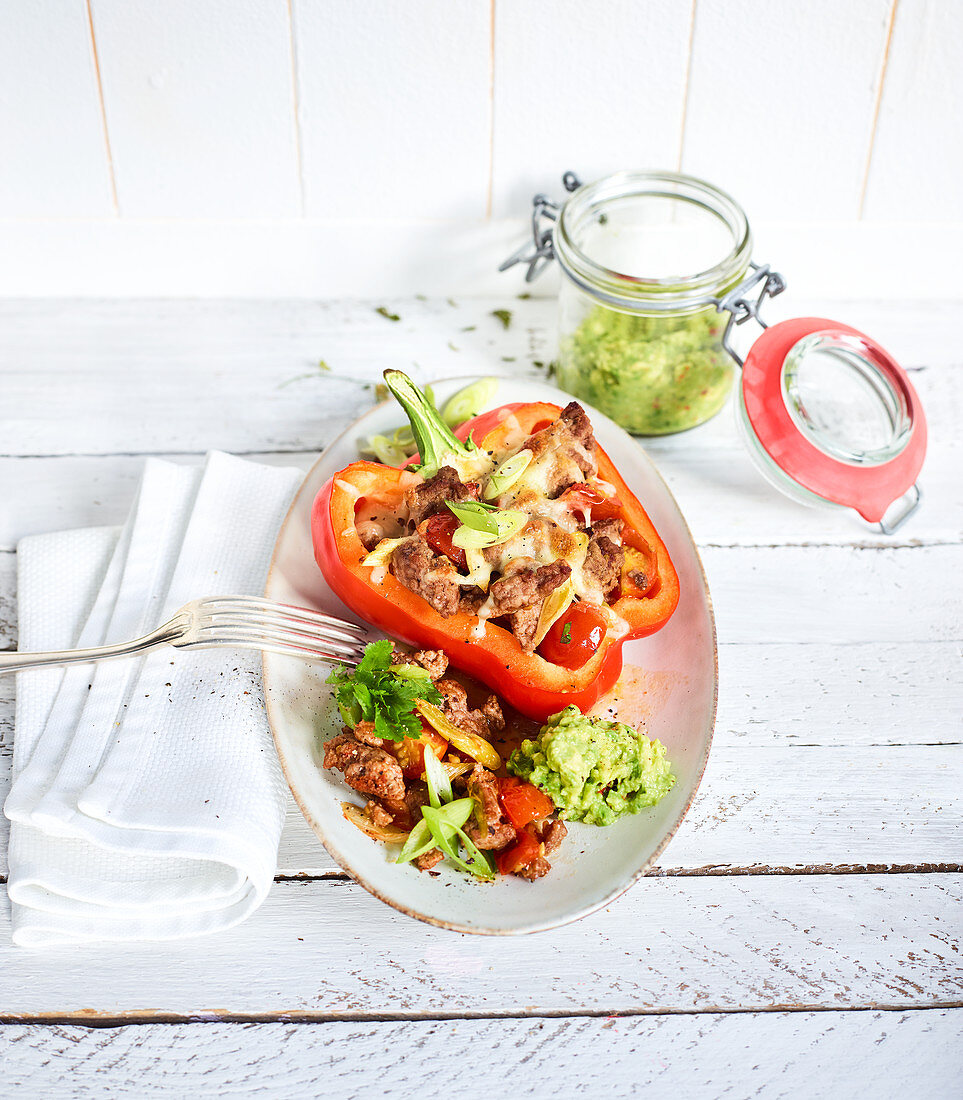 Peppers filled with minced meat served with guacamole