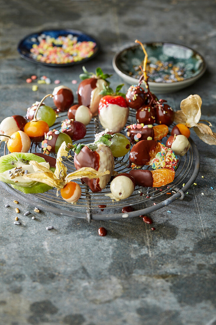 Colourful chocolate covered fruit on a cooling rack