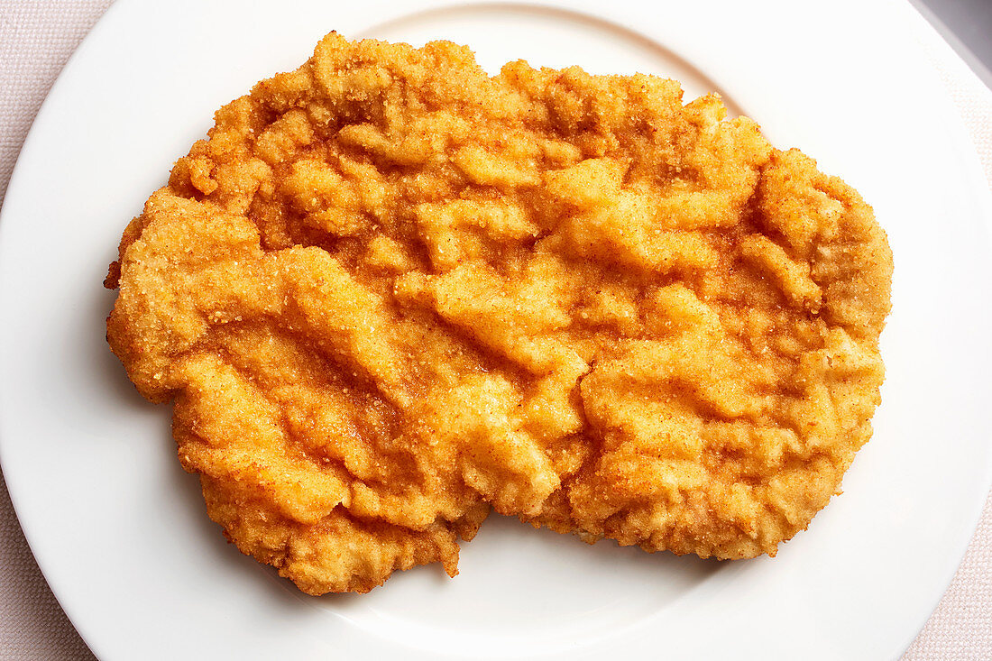 A Viennese escalope on a plate (seen from above)