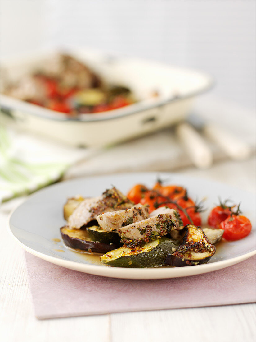 Pork fillet with herbs, mustard, zucchini and tomatoes