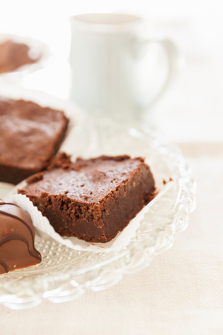 Brownies and chocolate confectionery on a glass dish