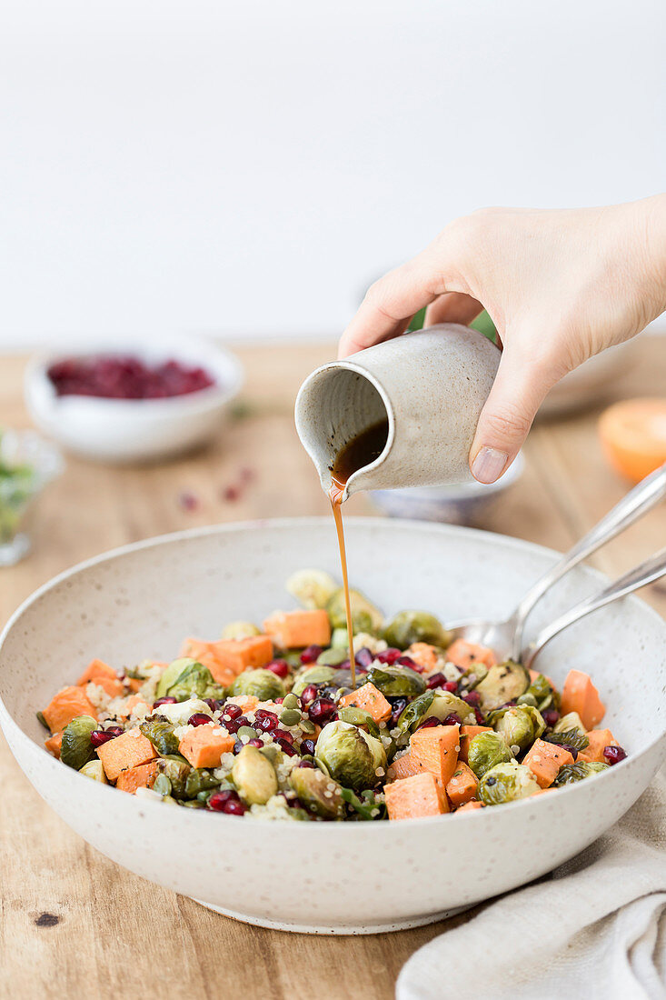 Fried brussels sprouts and sweet potato salad, drizzled with dressing