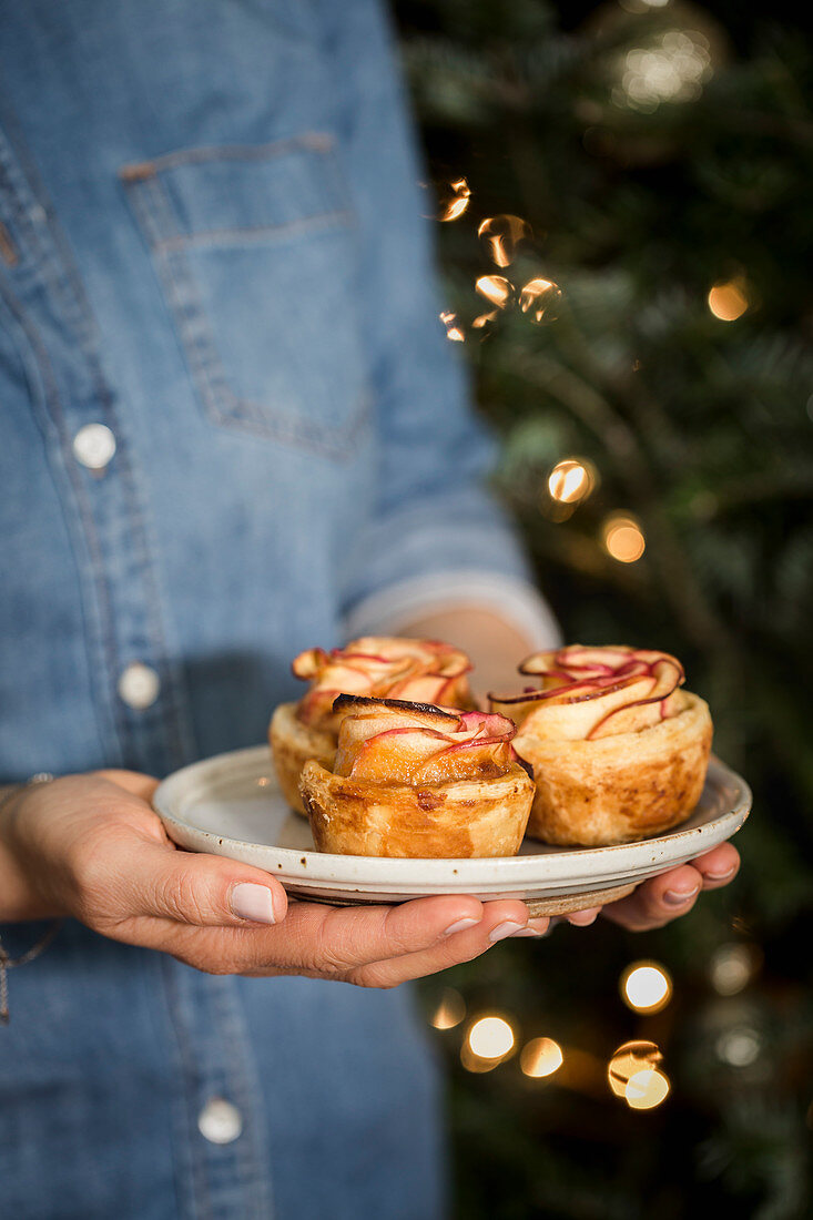 Apple Roses tarts held by a woman