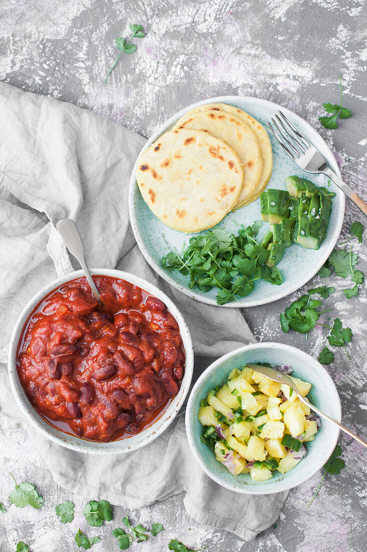 Vegan mexican tacos: Corn tacos, Avocado, Spicy and smoky black beans with tomato and chipotle sauce, Pineapple salsa with jalapeno and red onion