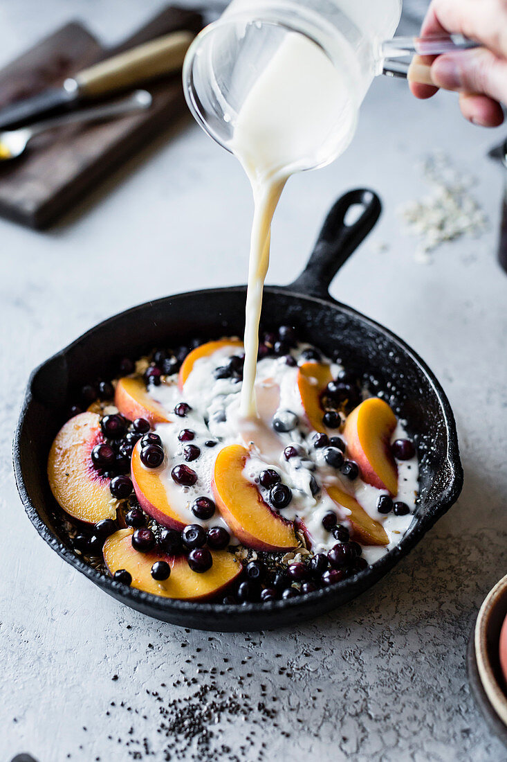 Super seedy vegan baked oatmeal with peaches and huckleberries