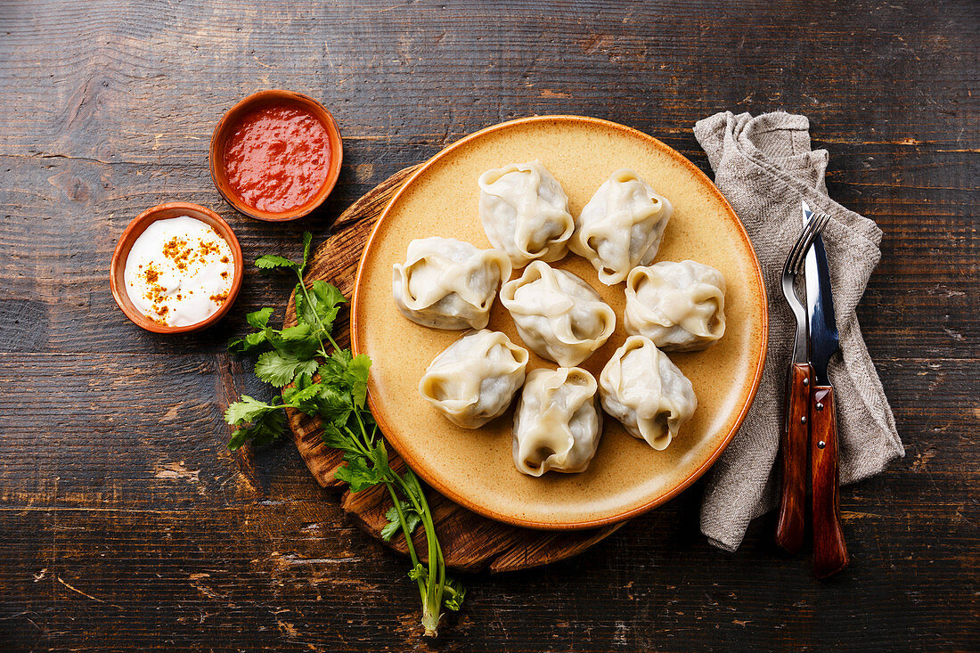 Traditional steamed dumplings Manty with Yogurt and Tomato sauce