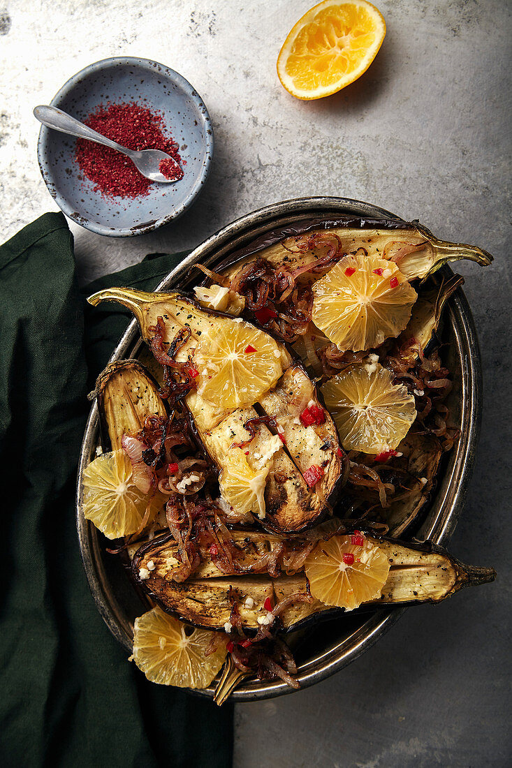 Traditional jewish and middle eastern food roasted eggplants with lemon, chili and caramelized onion