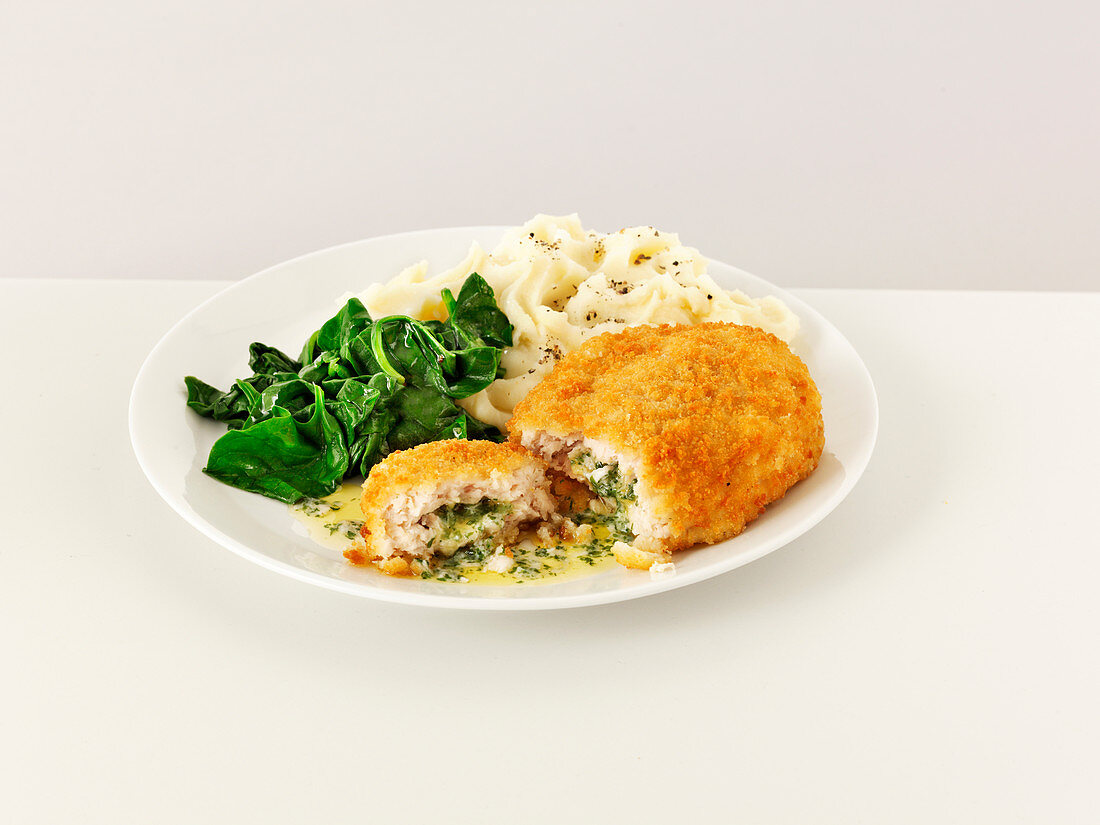 Chicken kiev with mashed potatoes and spinach