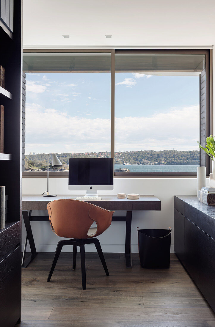 Study with designer armchair and sea view