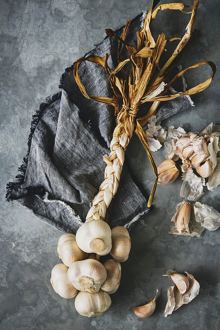 Rustic moody looking ingredient shot of a garlic plait