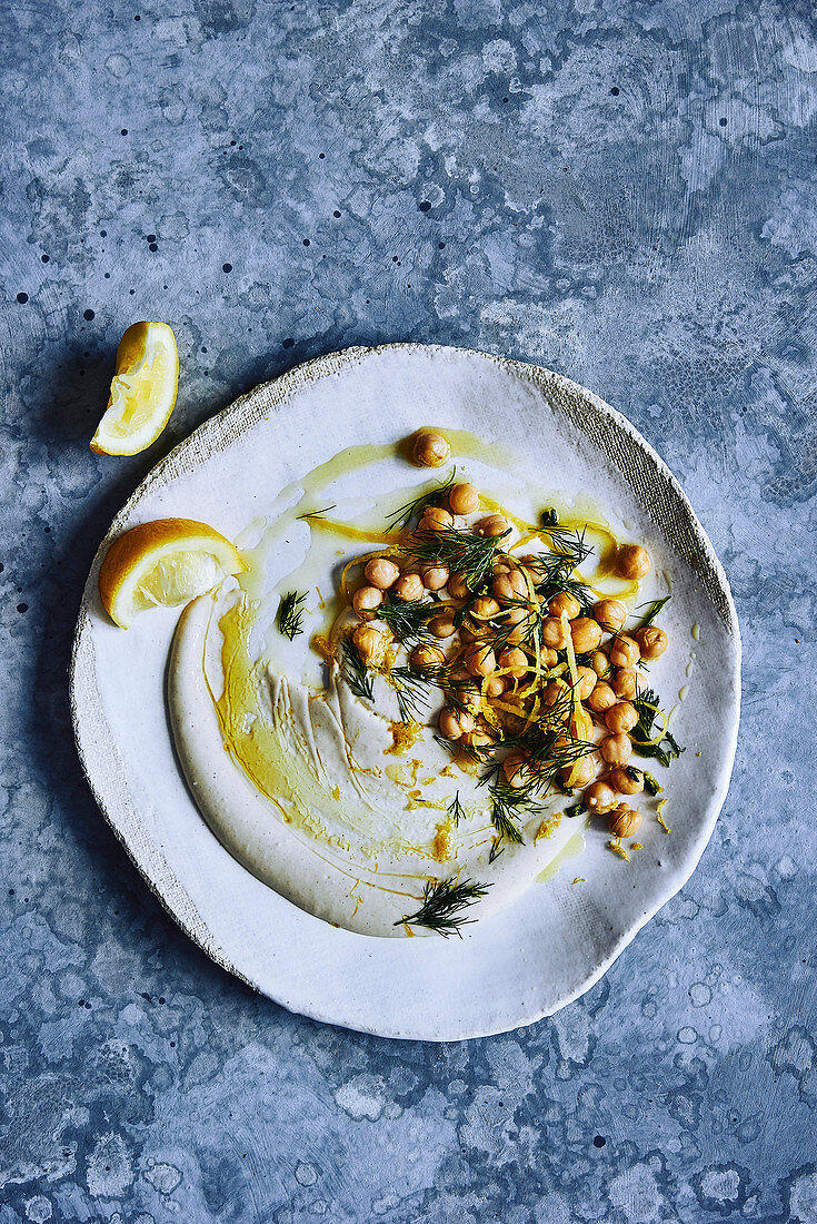 hommus dip with chickpeas, dill, lemon zest and a drizzle of olive oil