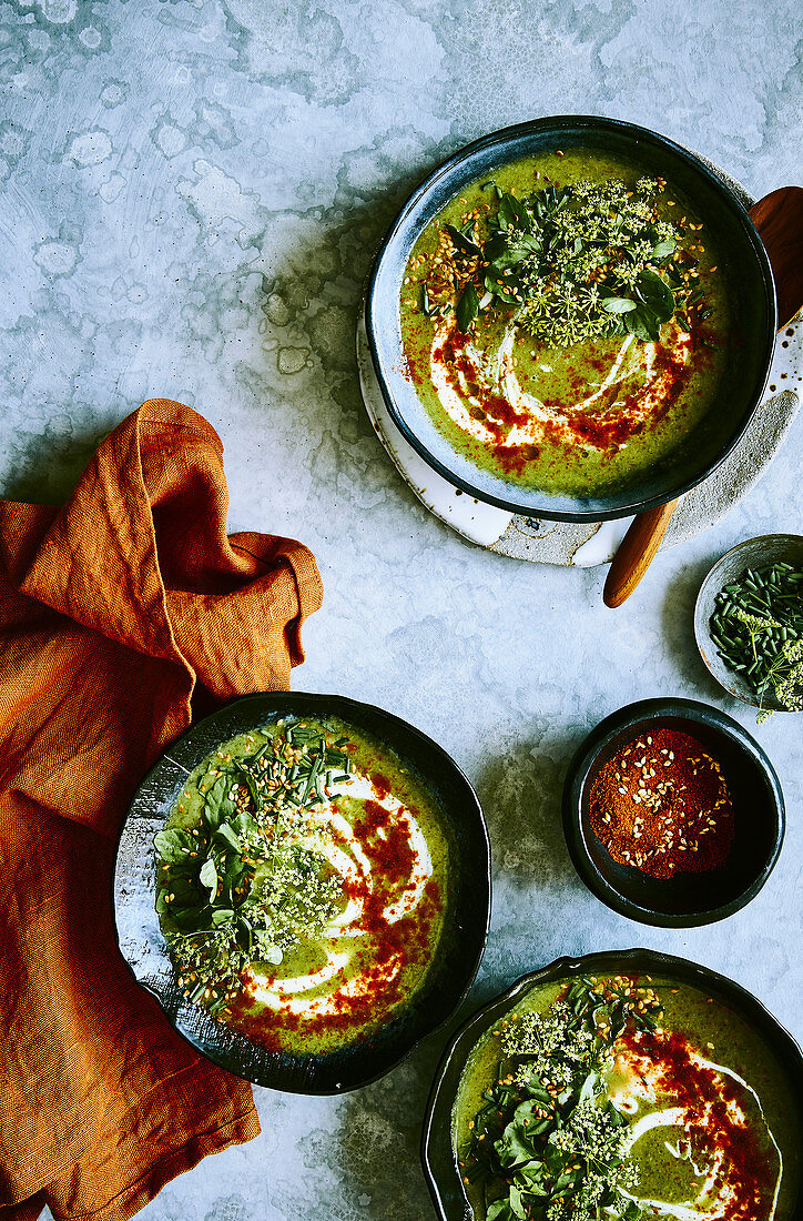 Healthy watercress and courgette soup with cayan pepper, yogurt and toasted sesame seeds