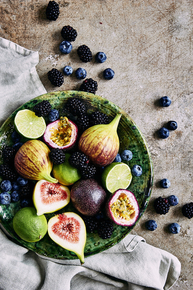 Fresh fruit platter, with figs, limes, blueberries, blackberries, and passion fruit