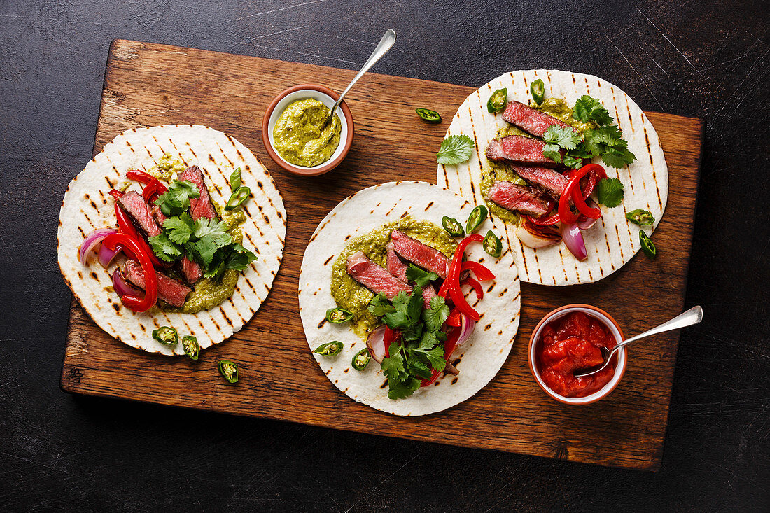 Grilled Beef steak Fajitas taco tortillas with salsa and bell pepper