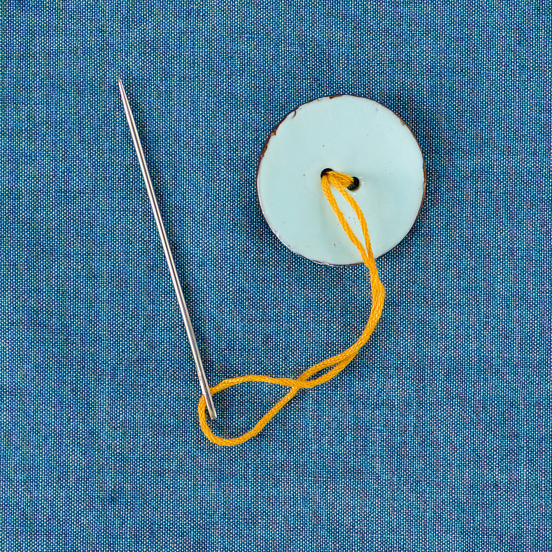 A button being sewn on