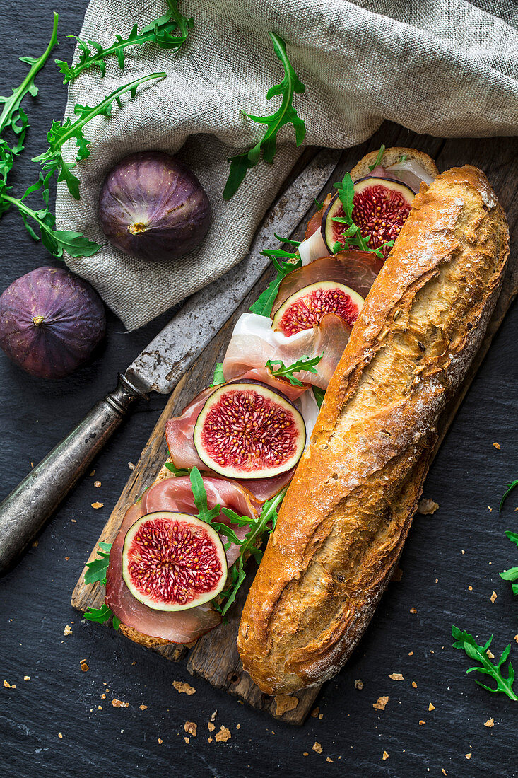 Baguette sandwich with figs, prosciutto and arugula