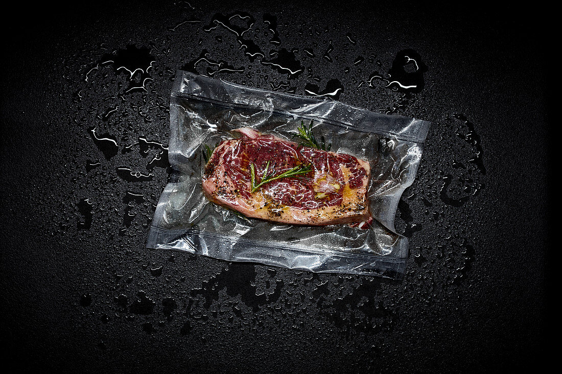 Beef steak with herbs in a sous vide bag