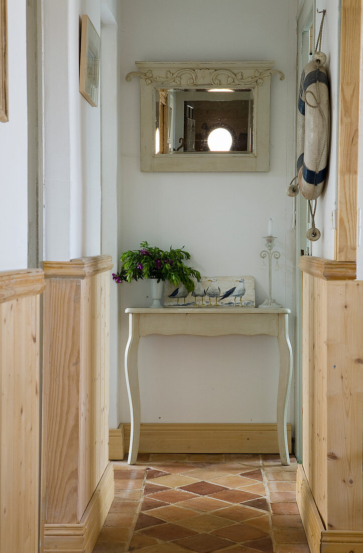 Wainscoting and terracotta floor tiles in hallway