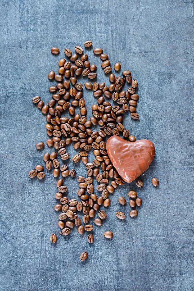 Top view of coffee beans and chocolate on grunge slate background