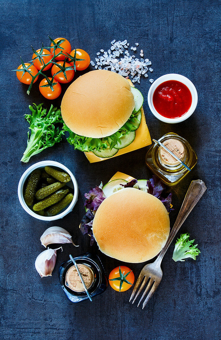 Two cheese sandwiches with fresh vegetables on dark vintage background