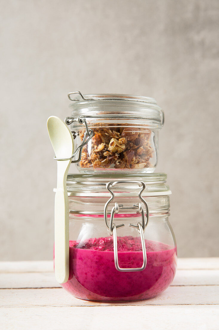 Beetroot and apple yoghurt with a nut mixture in jars to take away
