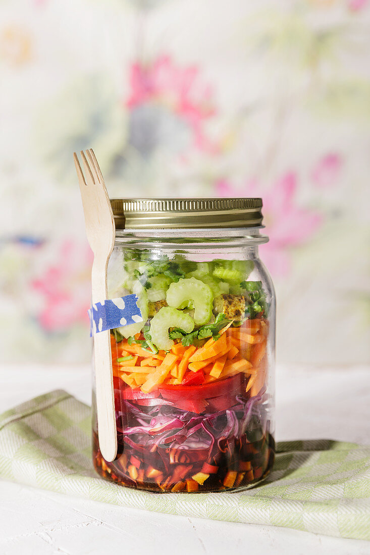 Low-carb oriental rainbow layered salad in a jar to take away