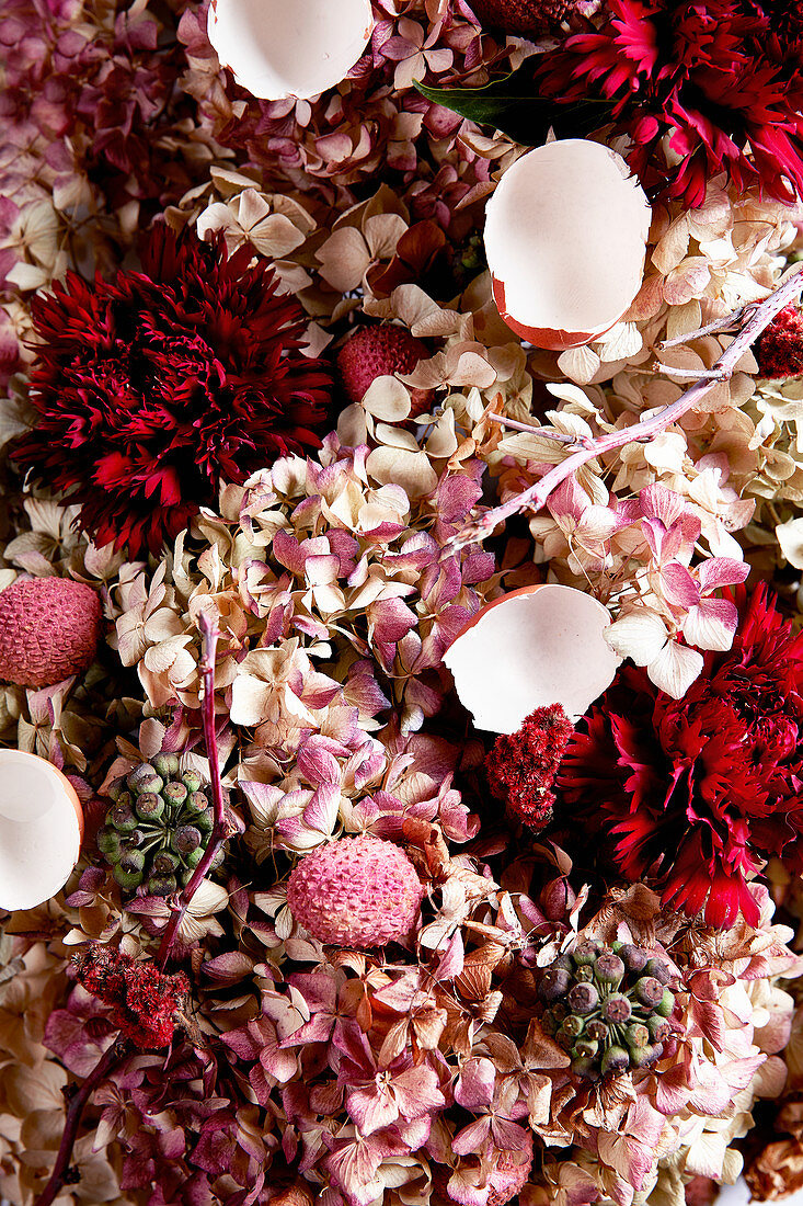 An arrangement of pink shades made from flowers, lychees and egg shells (full frame)