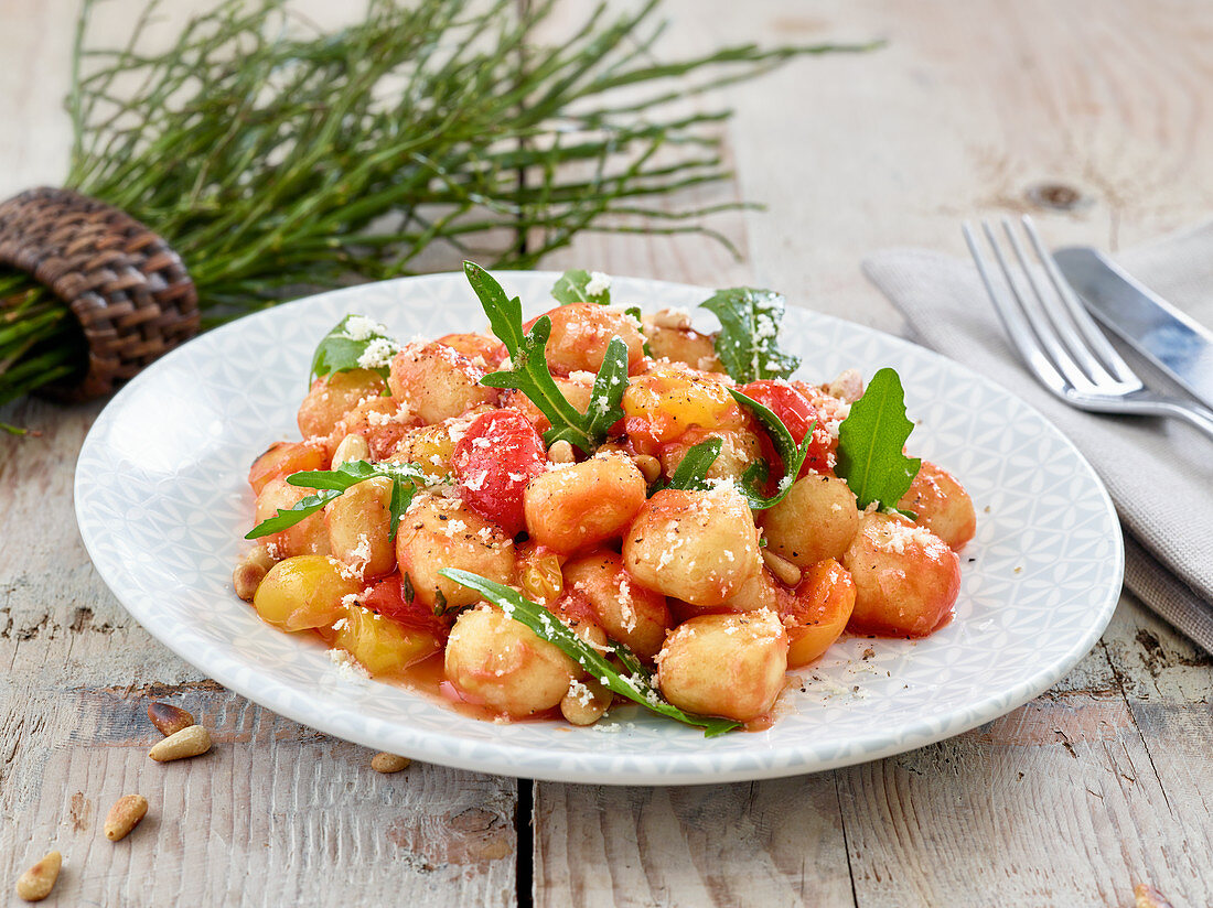 Gnocchi with tomato sauce, rocket and pine nuts